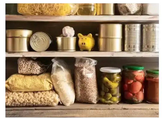 Pantry shelves stocked with pasta, legumes, cans, and mason jars